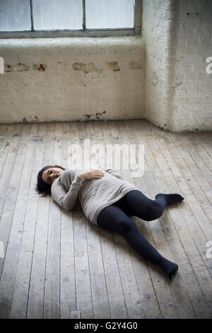 Dead woman's body on the floor Stock Photo