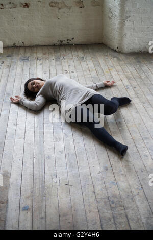 Dead woman's body on the floor Stock Photo