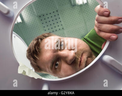 Man ready to  puke in the toilet bowl Stock Photo