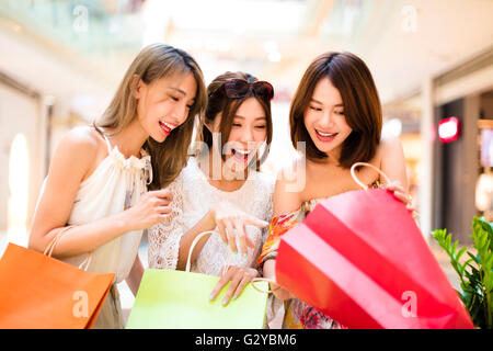 Surprised young women looking the shopping  bags Stock Photo