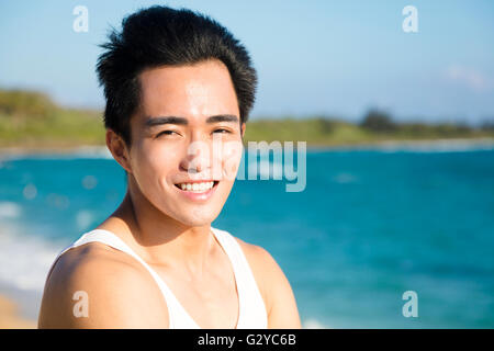 smiling young man on the beach Stock Photo