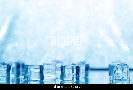 Many blue melting ice cubes on glass Stock Photo