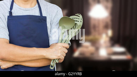 Asian Man Cross Arm With Cooking Tools Stock Photo