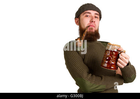 young bearded guy smoking a pipe on a light background Stock Photo