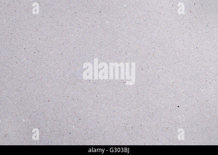 Rough gray natural cardboard background with colored dots and fibers Stock Photo