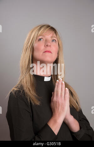 Portrait of a female clergy wearing a black shirt and clerical collar Stock Photo