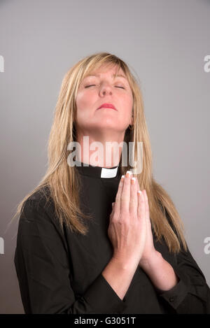 Portrait of a female clergy wearing a black shirt and clerical collar Stock Photo