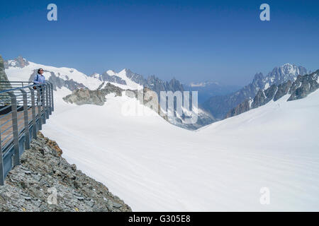 Unidentified women admiring the view from Punta Helbronner of Skyway ,panoramic terrace on Monte Bianco terminal in Aosta Valley Stock Photo