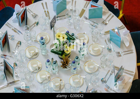 Overhead view of a round table set for a formal dinner. Stock Photo