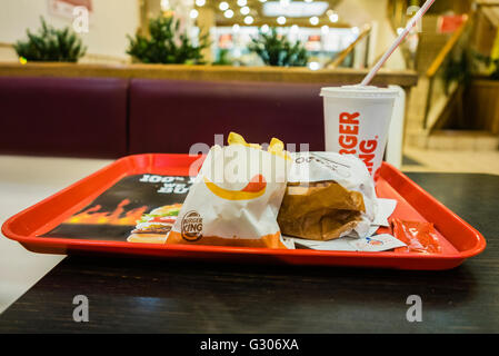 Hamburger, fries and drink on a tray in a Burger King fast-food restaurant Stock Photo