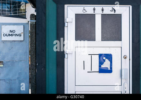 'No Dumping' sign beside a toilet. Stock Photo