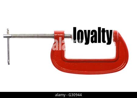 The word 'loyalty' is compressed with a vice. Stock Photo