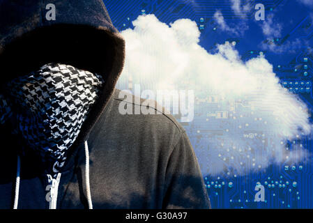 Hooded and masked computer hacker thief with a cloud computer based background and tech backdrop. Unknown technology threat to t Stock Photo