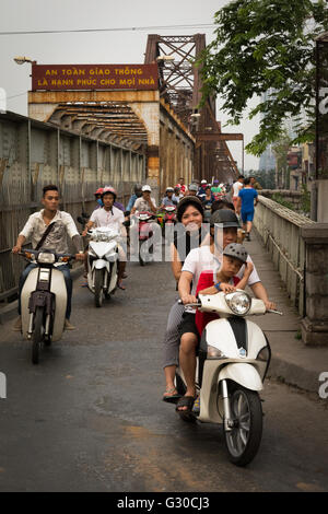 Commuters on motor scooters on the streets Hanoi, Vietnam. Stock Photo