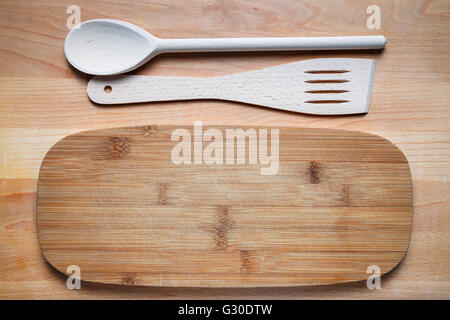 wooden cutlery on cutting board Stock Photo