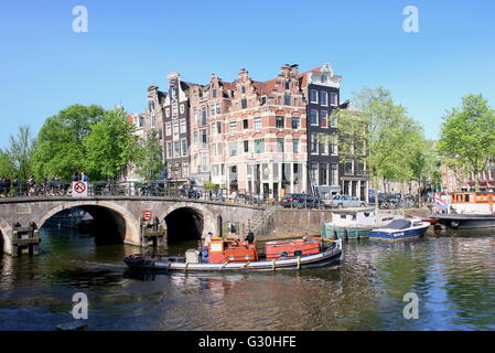 Historic stone bridge and 17th / 18th century houses where Prinsengracht meets Brouwersgracht canal in Amsterdam, Netherlands Stock Photo