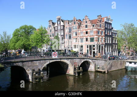 Historic stone bridge and 17th / 18th century houses where Prinsengracht meets Brouwersgracht canal in Amsterdam, Jordaa area, Netherlands