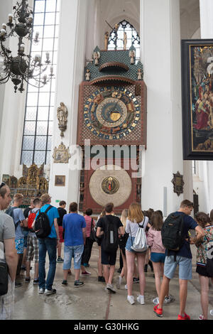 students people looking at the fifteenth century wooden astronomical clock in St Mary's Church, Gdansk Stock Photo