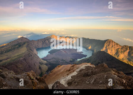 The Mt. Rinjani crater and a shadow cast from the peak at sunrise Stock Photo