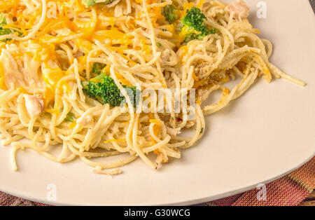 Chicken Alfredo. Plate of delicious and easy to prepare chicken alfredo topped with shredded cheese and broccoli. Stock Photo