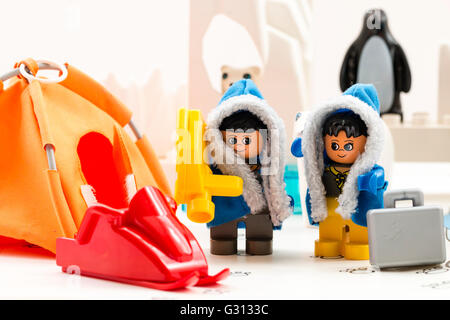 Lego duplo explore Arctic toy playset. Two lego characters, man and woman, in base camp, with polar bear, icebergs and penguin behind. Stock Photo