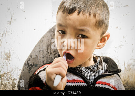 Kid Brushing his Teeth in Nepal Stock Photo