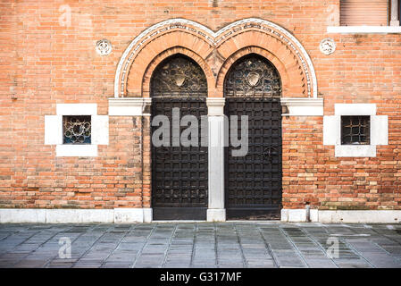 Double access doors in the medieval city of Venice. Stock Photo