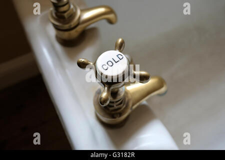 brass cold tap on old victorian style bath Stock Photo