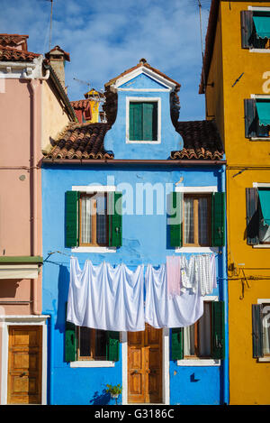Hung laundry on the lines in front of houses in Burano. Stock Photo