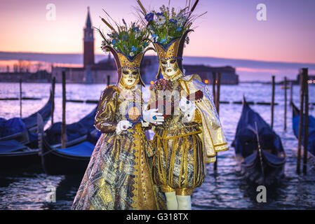 Costumed couple on the San Marco square during Carnival in Venice Stock Photo