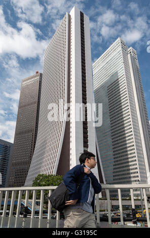 Businessman in front of Shinjuku Center, Sompo and Nomura Buildings, Nishi-Shinjuku, Tokyo, Japan Stock Photo