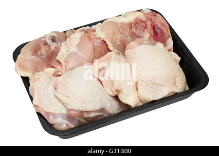 Chicken fresh thighs with bones and skin in the standard trade plastic container. Isolated with patch Stock Photo