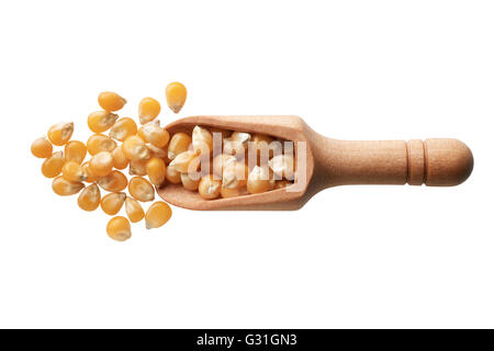 Food ingredients: heap of dried corn seeds in a wooden scoop, on white background Stock Photo