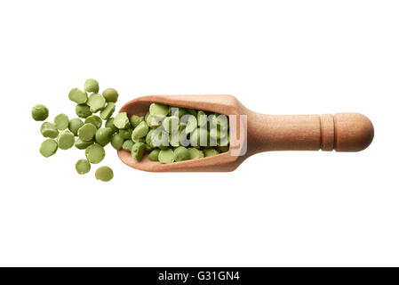 Food ingredients: heap of dried green peas in a wooden scoop, on white background Stock Photo