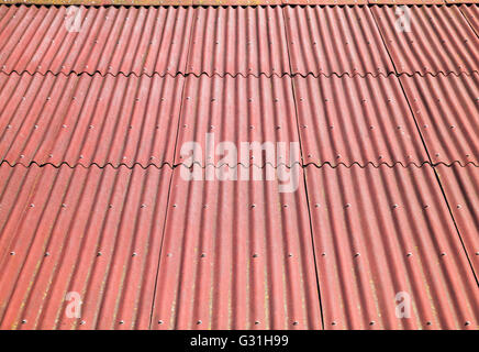 Red roof made of corrugated cardboard bituminous, background photo texture with perspective effect Stock Photo