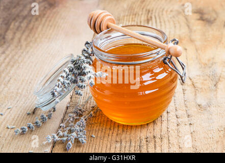 Healthy organic lavender honey in a jar with flowers Stock Photo