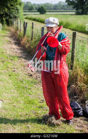 Burghfield, UK. 6th June, 2016. A peace campaigner plays a trombone outside AWE Burghfield in Berkshire to begin a month of action against Trident renewal intended “to blockade, to occupy and to disrupt” the factory responsible for the final assembly of Trident mounted nuclear warheads. Credit:  Mark Kerrison/Alamy Live News Stock Photo