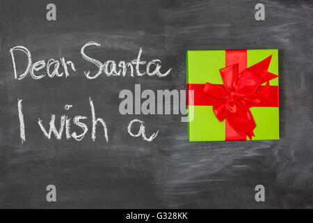 Dear Santa is written on a blackboard and christmas decoration Stock Photo
