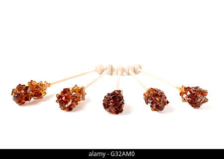Five brown sugar stirrers isolated on white. Stock Photo
