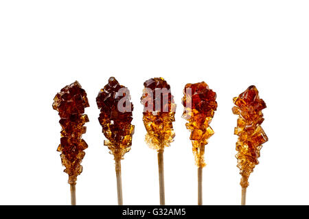 Close up of five brown sugar stirrers isolated on white. Stock Photo