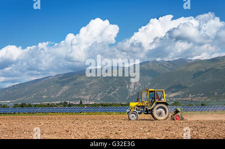 Tractor working in the field. Time of sowing. Stock Photo