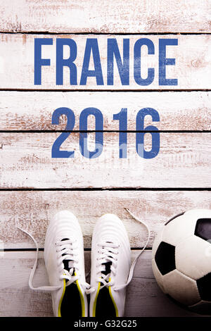 Soccer ball, cleats and France 2016 sign, studio shot. Stock Photo