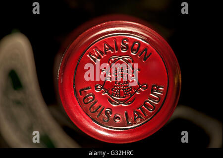 Louis Latour encapsulation bottle top close up on fine red Burgundy wine bottle stored in controlled temperature wine cabinet Stock Photo