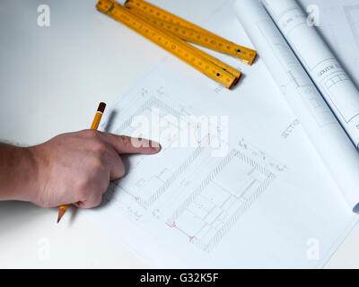 Business man draw buildings and present his architectural project Stock Photo