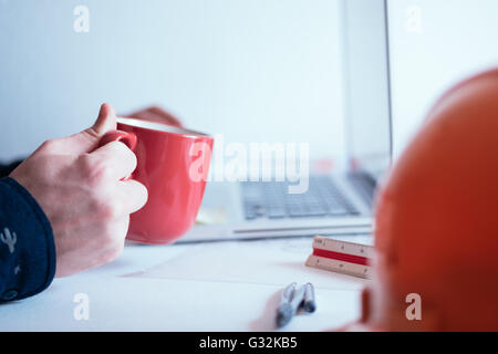 Cropped image of male architect using laptop in office Stock Photo