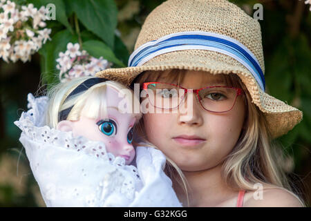 6- 7 year old girl with her doll Stock Photo