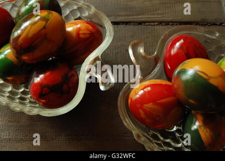 Multi-colored easter eggs in glass bowls Stock Photo