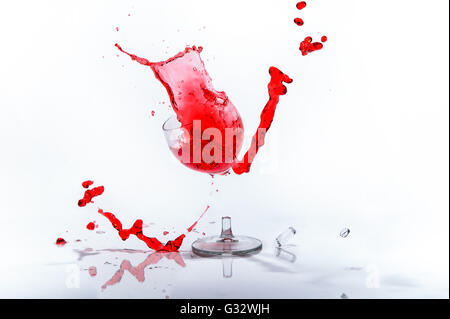 Glass of red liquid in broken wine glass Stock Photo