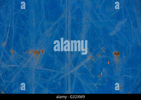 a detail image of random scratches on a blue metal panel Stock Photo