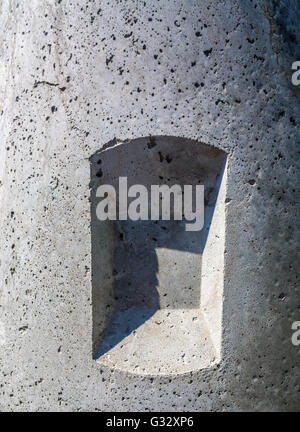 an abstract form consisting of a shadowed depression in concrete Stock Photo